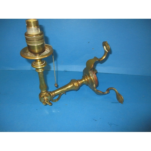 An early 20th century Osler brass wall mounted lamp, having adjustable angle head, in good used condition, marked to base