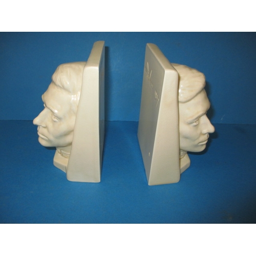 260 - A pair of Beswick matt glazed creamware bookends, by Felix Weiss dated 1937, one having a chip to ba... 