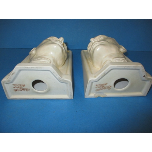 260 - A pair of Beswick matt glazed creamware bookends, by Felix Weiss dated 1937, one having a chip to ba... 