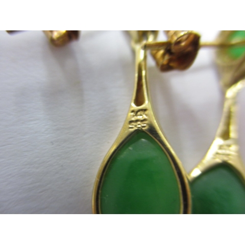 30 - A pair of 14k yellow gold earrings, each with bright green stones, approx. gross parcel weight 2.9g,... 