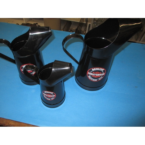 A set of 3 graduated oil jugs, advertising Harley Davidson Motor Oil, in good useable pre-owned condition