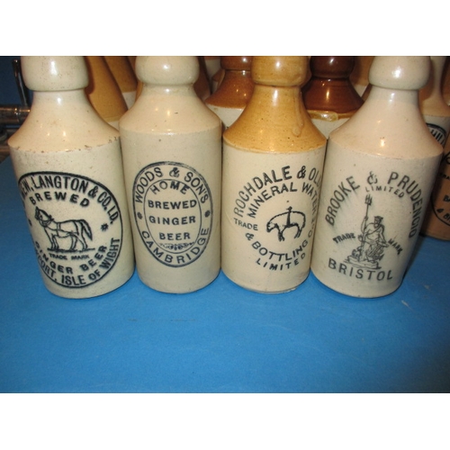 123 - 34 Vintage stoneware ginger beer bottles to include blue and green top examples, all in used conditi... 