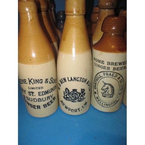 123 - 34 Vintage stoneware ginger beer bottles to include blue and green top examples, all in used conditi... 