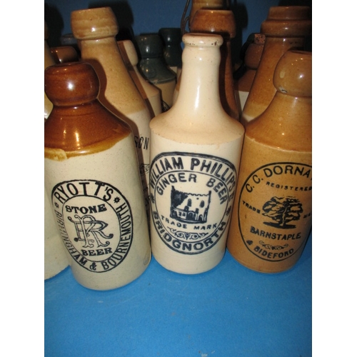 123 - 34 Vintage stoneware ginger beer bottles to include blue and green top examples, all in used conditi... 