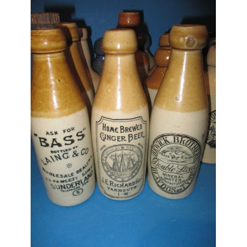 123 - 34 Vintage stoneware ginger beer bottles to include blue and green top examples, all in used conditi... 