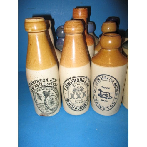 123 - 34 Vintage stoneware ginger beer bottles to include blue and green top examples, all in used conditi... 