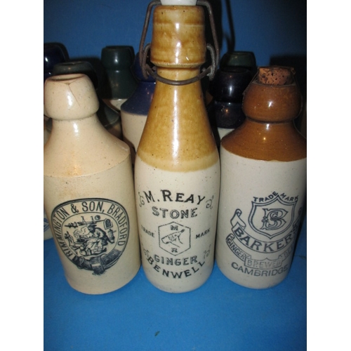 123 - 34 Vintage stoneware ginger beer bottles to include blue and green top examples, all in used conditi... 