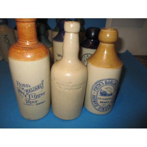 123 - 34 Vintage stoneware ginger beer bottles to include blue and green top examples, all in used conditi... 