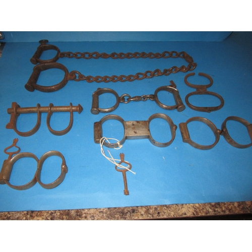 104 - A parcel of antique and later handcuffs, to include a hand to ankle set, most with keys, all with ge... 