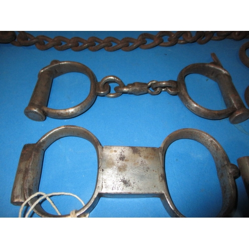 104 - A parcel of antique and later handcuffs, to include a hand to ankle set, most with keys, all with ge... 