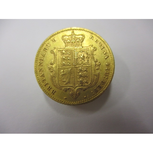 31 - A Victorian gold half sovereign dated 1859 with shield back, a circulated coin with very good defini... 