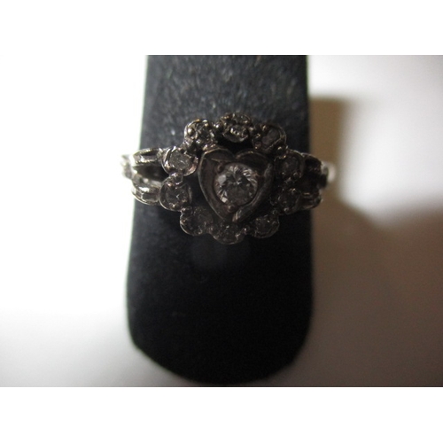 3 - A vintage 18ct gold and diamond ring, with central diamond set heart shaped motif, approx. ring size... 