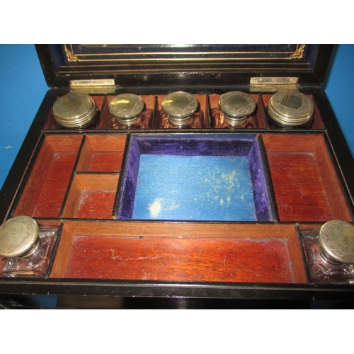 85 - A 19th century travelling vanity chest, having original white metal mounted bottles, drawers and hid... 