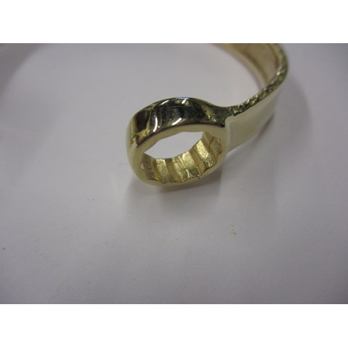 20 - A 9ct yellow gold bangle in the form of a combination spanner, approx. weight 42.5g, in good useable... 