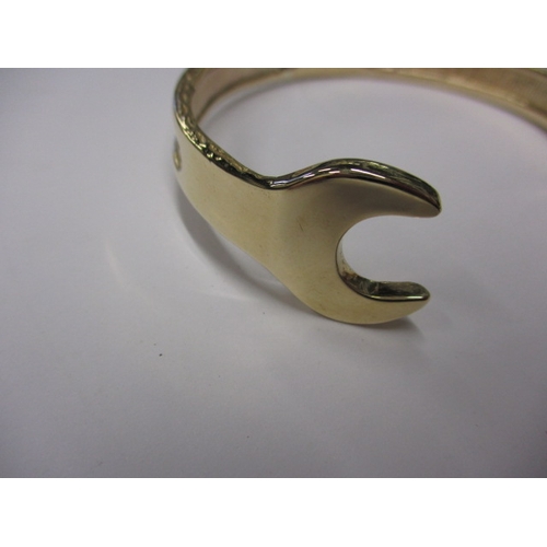 20 - A 9ct yellow gold bangle in the form of a combination spanner, approx. weight 42.5g, in good useable... 