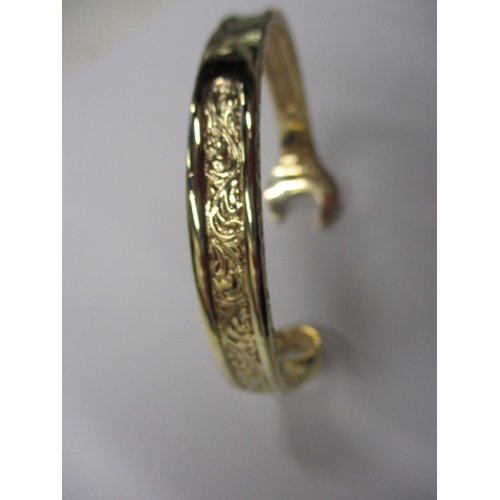 20 - A 9ct yellow gold bangle in the form of a combination spanner, approx. weight 42.5g, in good useable... 