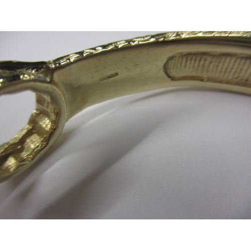 20 - A 9ct yellow gold bangle in the form of a combination spanner, approx. weight 42.5g, in good useable... 