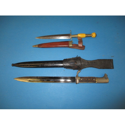 97 - A vintage German bayonet, Carl Eickhorn, Solingen, and a dagger with ivorine mount, both with scabba... 