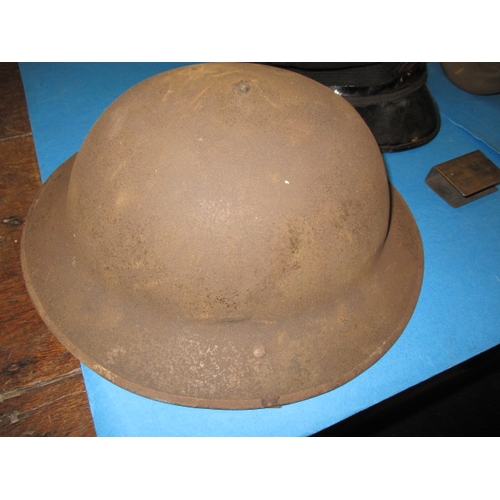 96 - A parcel of military related items to include helmets and a match box cover, all in used condition