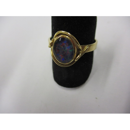 6 - A 750 yellow gold ring with central cabochon opal, approx. ring size ‘S’ approx. weight 4.2g, in goo... 