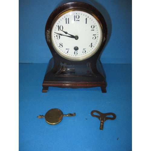 89 - An antique mantle clock with mahogany case, approx. height 18cm, with key and pendulum