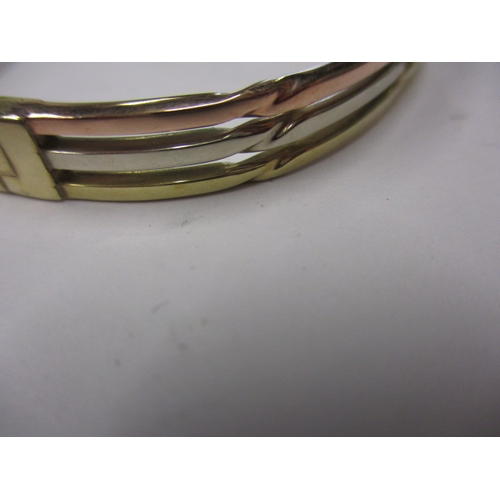 44 - A 9ct tri-colour gold bangle, approx. weight 14g, clasp opening clip broken