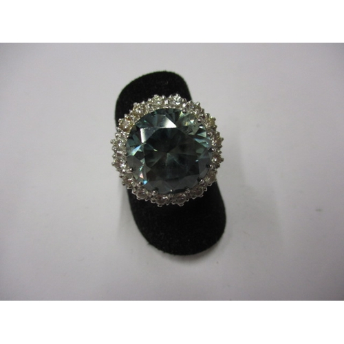 11 - An 18ct yellow and white gold blue zircon and diamond dress ring, set with a central 14mm round blue... 