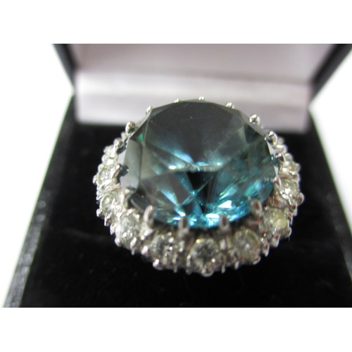 11 - An 18ct yellow and white gold blue zircon and diamond dress ring, set with a central 14mm round blue... 