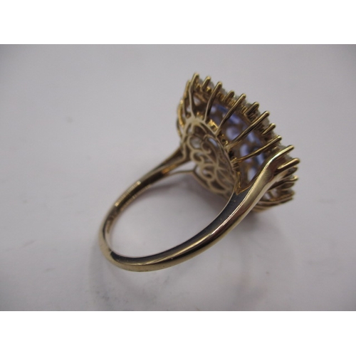 7 - A 9ct yellow gold cluster ring with white stones around tanzanite, approx. ring size ‘R ½ ‘, approx.... 