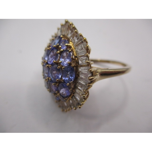 7 - A 9ct yellow gold cluster ring with white stones around tanzanite, approx. ring size ‘R ½ ‘, approx.... 