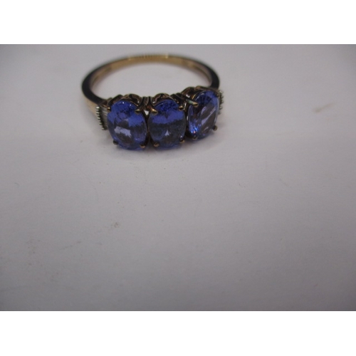 13 - A 9ct yellow gold 3 stone tanzanite dress ring with diamond set shoulders, approx. ring size ‘R’, ap... 