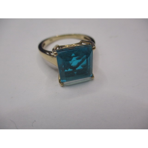 23 - A 9ct yellow gold dress ring with large turquoise blue crystal, approx. ring size ‘Q’, approx. weigh... 