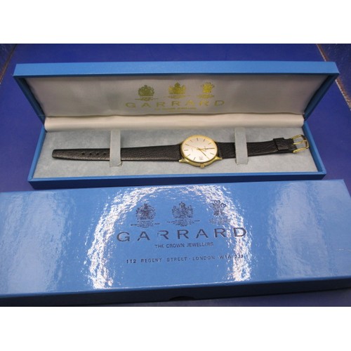 106 - A Garrards gold cased gents wrist watch, in unused condition with original box, inscribed to back, n... 