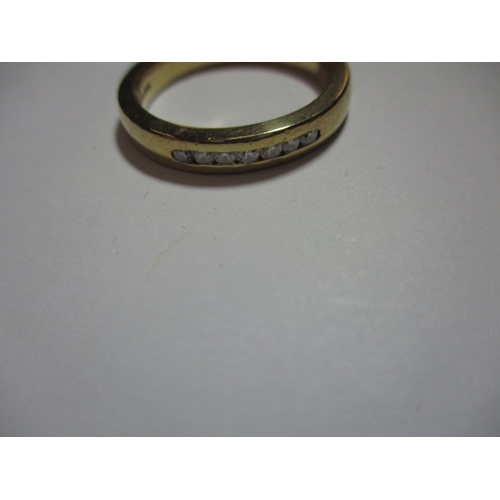 19 - An 18ct yellow gold ring with 7 channel set diamonds, approx. ring size ‘R’ approx. weight 7g, in us... 