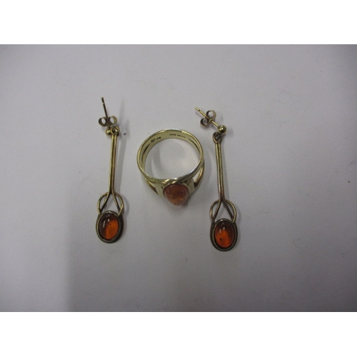 25 - A 9ct gold ring with amber cabochon and matching earrings, approx. gross parcel weight 7.4g, in usea... 