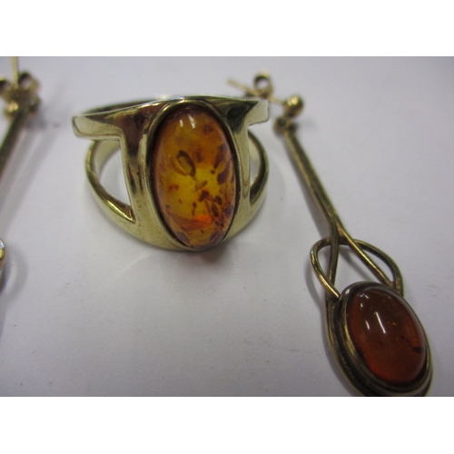 25 - A 9ct gold ring with amber cabochon and matching earrings, approx. gross parcel weight 7.4g, in usea... 