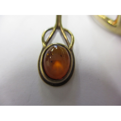 25 - A 9ct gold ring with amber cabochon and matching earrings, approx. gross parcel weight 7.4g, in usea... 