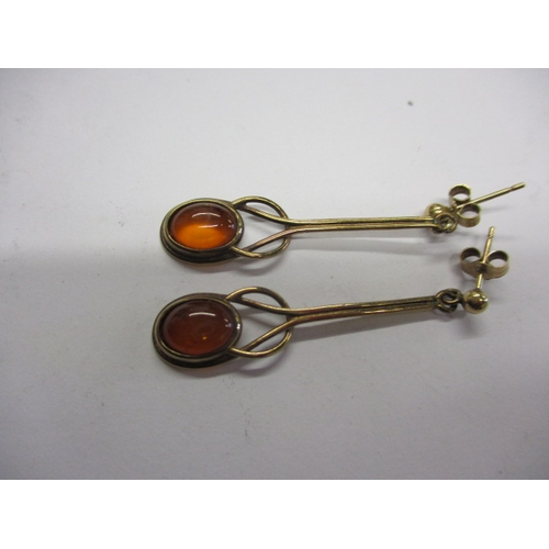 25 - A 9ct gold ring with amber cabochon and matching earrings, approx. gross parcel weight 7.4g, in usea... 