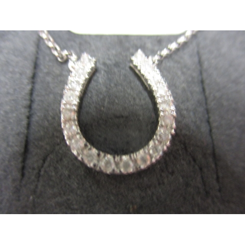 50 - A 9ct white gold necklace chain with diamond set horseshoe pendant, new old stock in retailers box