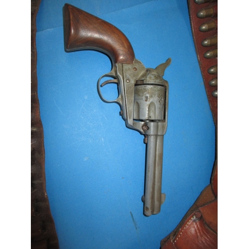 25 - A vintage replica revolver in leather holster and a leather cartridge belt, in useable pre-owned con... 