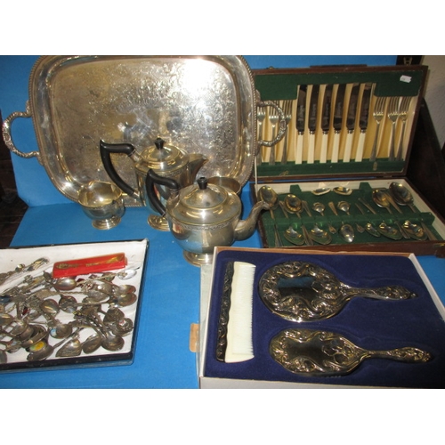 72 - A canteen of cutlery, a boxed silver plated dressing table set, collectable spoons and a tea set on ... 