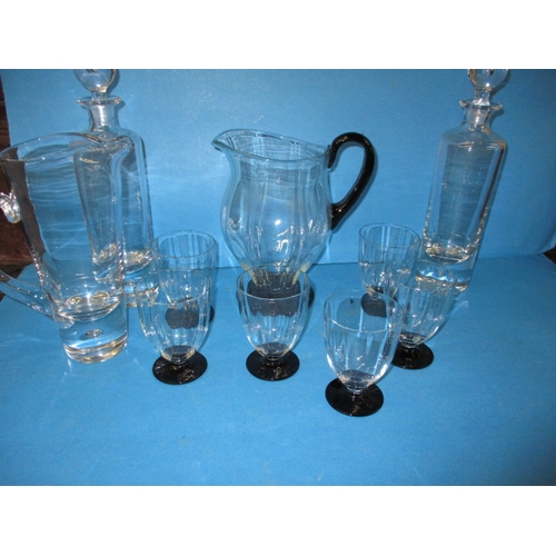 85 - A quantity of glass items to include a 7 piece lemonade set, 2 Kosta Boda glass decanters and matchi... 