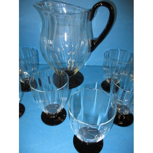 85 - A quantity of glass items to include a 7 piece lemonade set, 2 Kosta Boda glass decanters and matchi... 