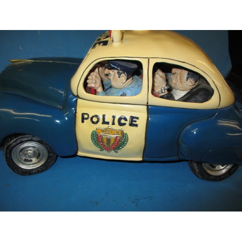 99 - A Guillermo Forchino comic art police car and a model sports car, both in boxes