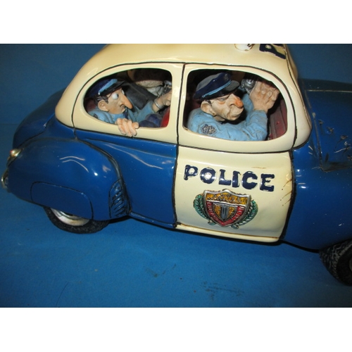 99 - A Guillermo Forchino comic art police car and a model sports car, both in boxes