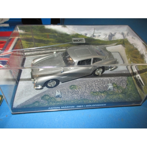 101 - A quantity of die-cast model vehicles, to include a 1:18 scale Aston Martin V12 Vanquish, all in unu... 