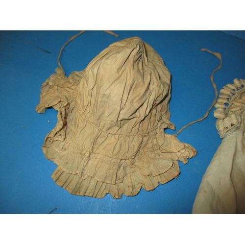 112 - An antique baby bonnet and gown, having age-related marks and ware