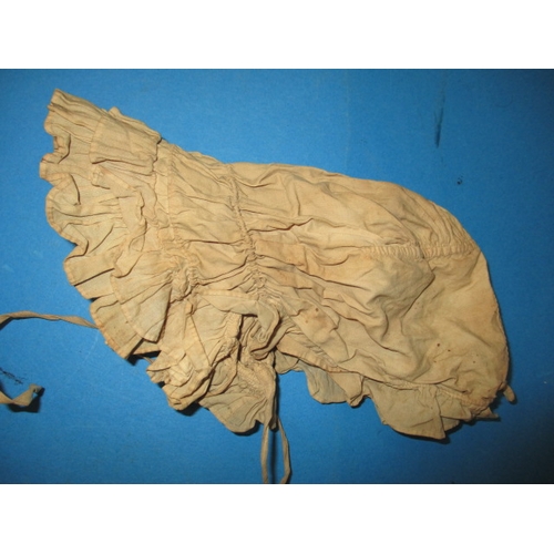 112 - An antique baby bonnet and gown, having age-related marks and ware