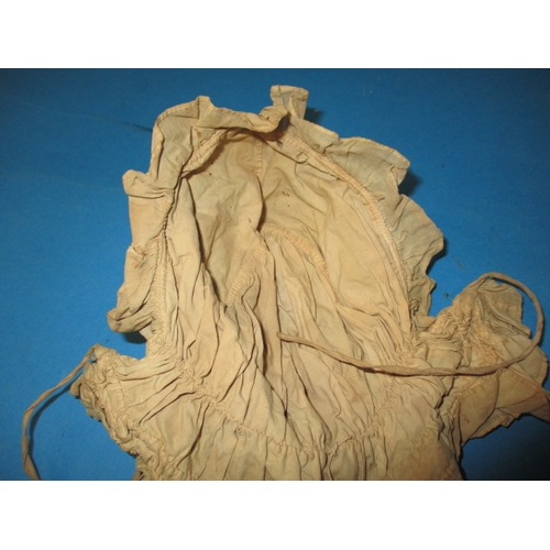 112 - An antique baby bonnet and gown, having age-related marks and ware