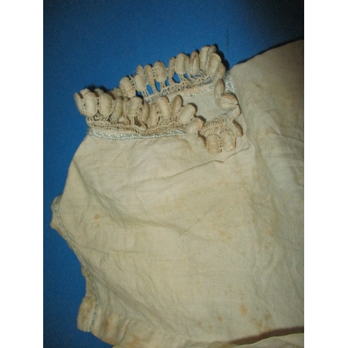 112 - An antique baby bonnet and gown, having age-related marks and ware